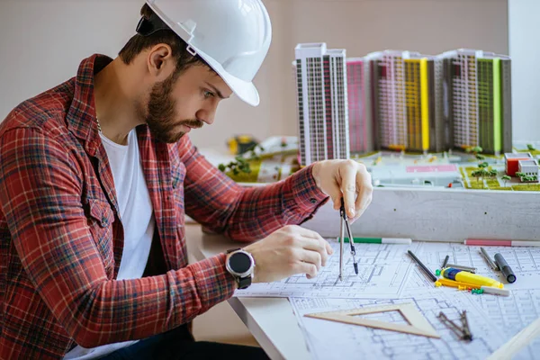 Zijaanzicht op geconcentreerde bouwer mens maken tekening — Stockfoto