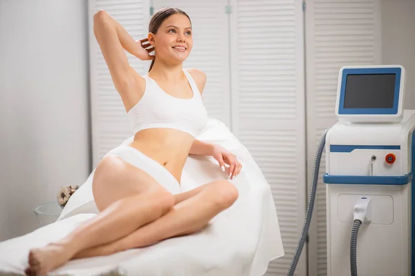 Slender woman happy to get laser epilation — Stock Photo, Image