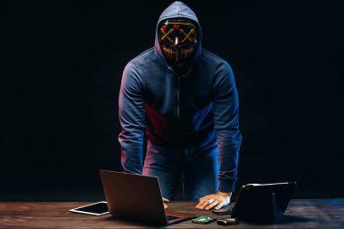 anonymous hacker man isolated over dark space clipart