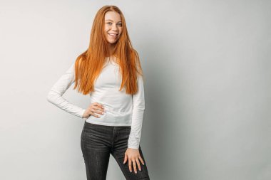 cheerful red haired girl isolated over white background