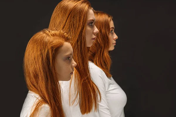 Side view on three redhead sisters isolated — Stockfoto