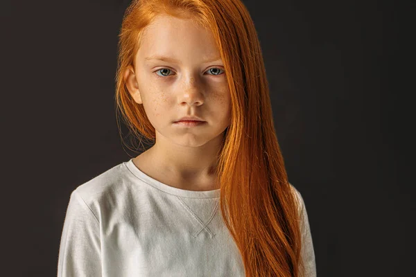 Portrait of serious redhaired girl isolated over black background — 스톡 사진