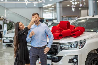 smiling couple with new bought dealership