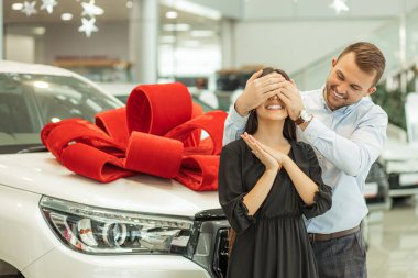 smiling caucasian guy make surprise to happy wife