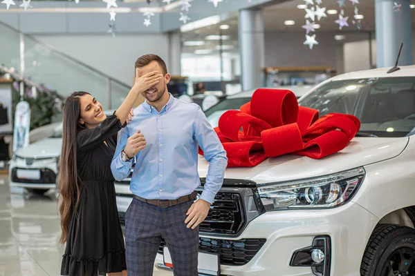 smiling couple with new bought dealership