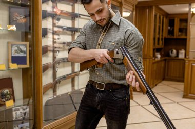 confident male in guns store