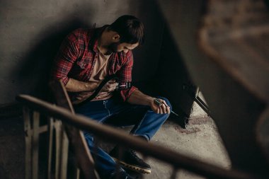 young drug user injecting heroin into veins