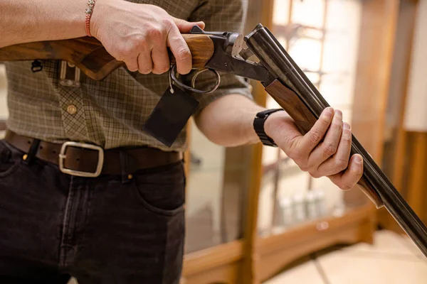 man reload a rifle in guns store