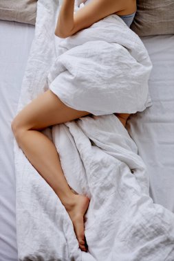cropped woman lying on bed, sleep
