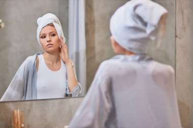 attractive lady look at mirror in bathroom