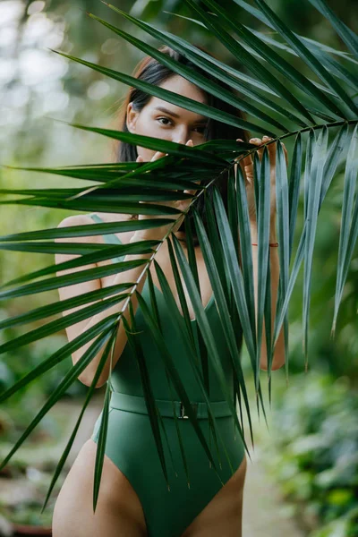 Young beautiful model around green fresh plants — Stok fotoğraf