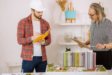 inexperienced student and professional mature architect in office