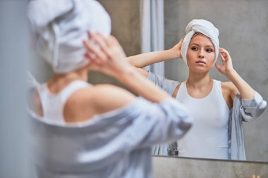 attractive lady look at mirror in bathroom