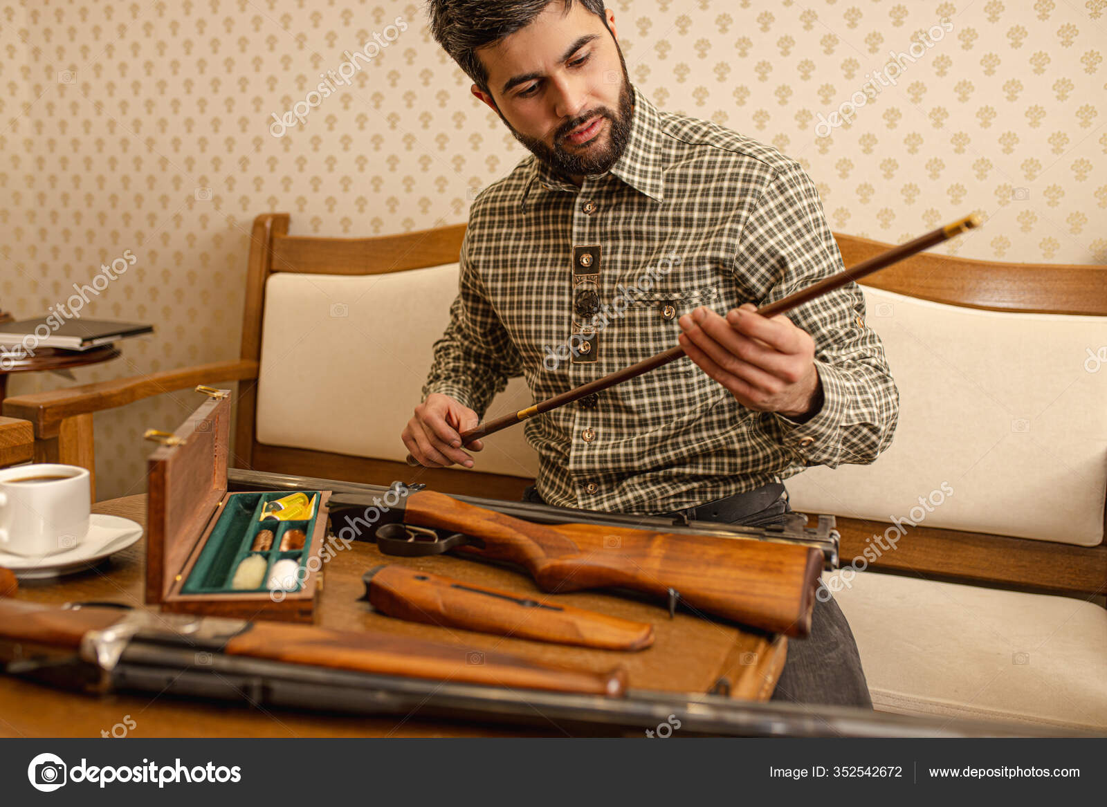 Handsome guy looking at rifle in hands Stock Photo by ©romanchazov27 ...