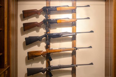 different rifles on showcase in guns store