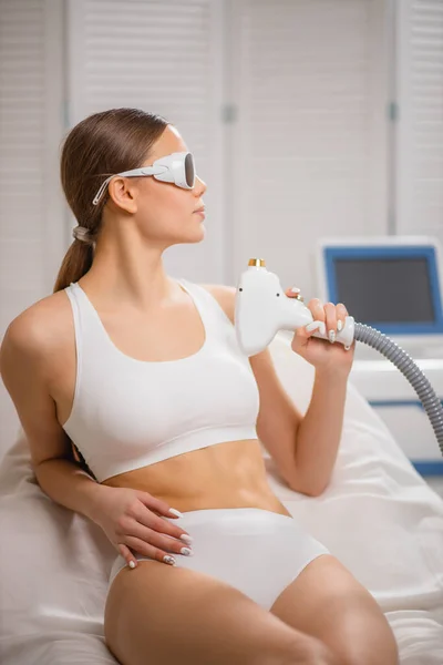 Young woman hold apparatus for laser epilation — Stock Photo, Image