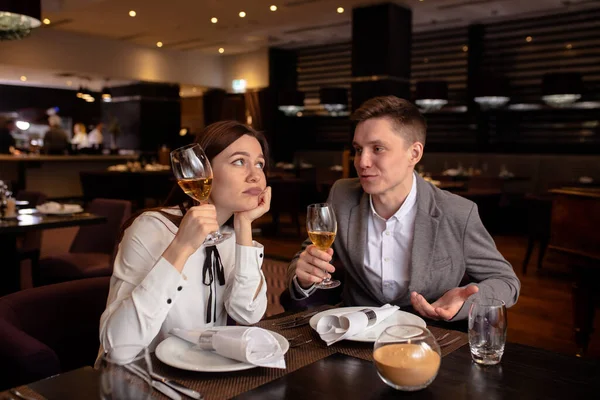 退屈した女性とシャンパンと男性が彼女を楽しませ — ストック写真