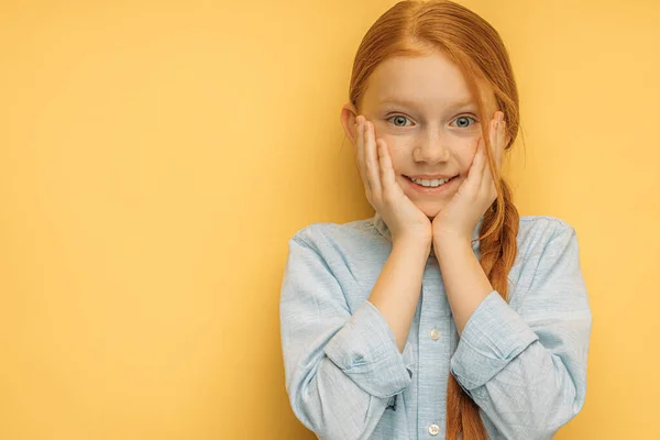 portrait of beautiful positive red haired kid girl isolated