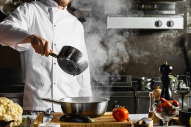 Yemek pişirme sürecinde profesyonel genç aşçı