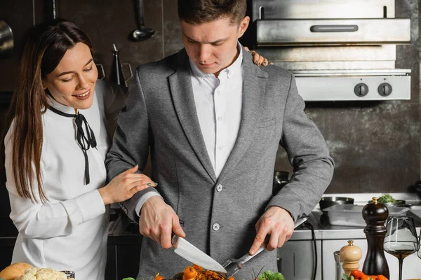 Jovem casal caucasiano na master class com o cozinheiro — Fotografia de Stock