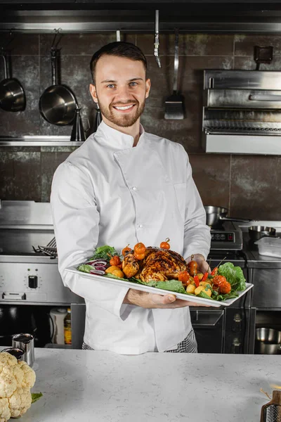 portrait of handsome chef-cook in kitchen