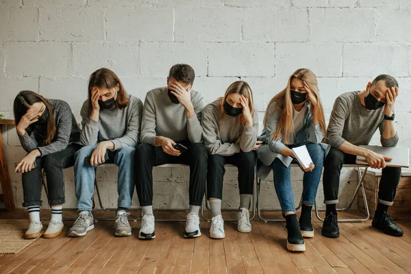 ill young people in line for a doctors appointment