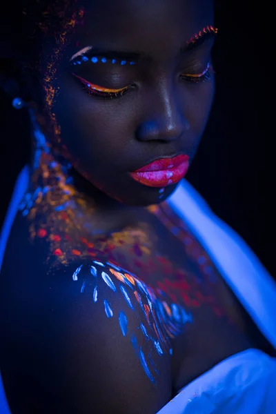 beautiful extraterrestrial african model woman in neon light