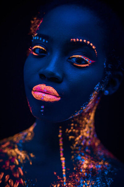 Portrait of beautiful african fashion model in neon UF light