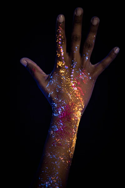 womans hands with fluorescent prints