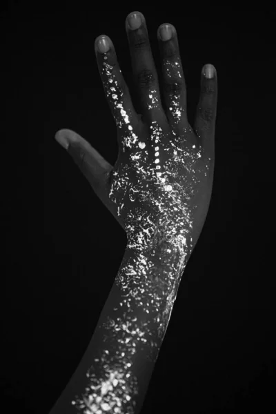 close-up of female hands with fluorescent prints
