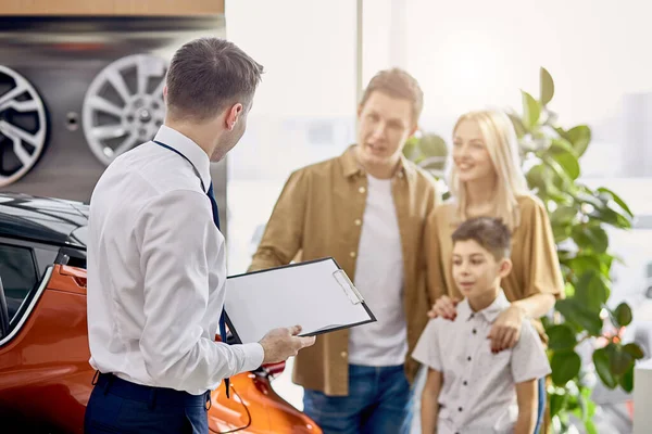 Hermosa familia tener conversación con afable vendedor agradable — Foto de Stock