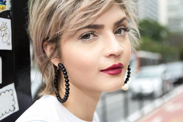 Short haired woman in urban cityscape.