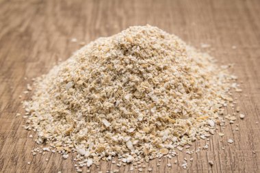 Avena Sativa, Yulaf gevreğinin bilimsel adıdır. Aveia ya da Avena olarak da bilinir. Tahta masadaki tahıl yığını. Seçici odak.