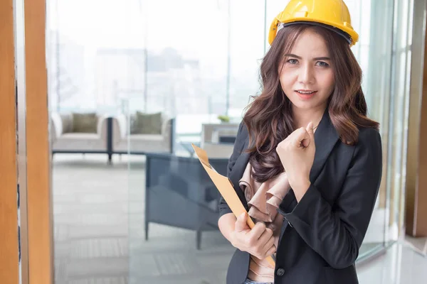 Beautiful Asia business woman over blured office background.