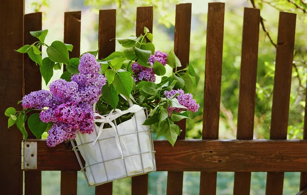 Purple Lilac flowers in basket — Stock Photo, Image