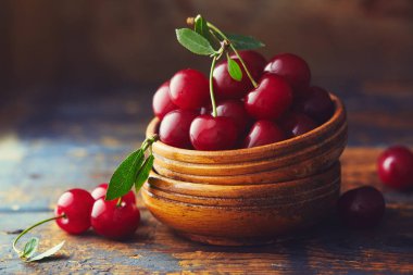 Ahşap bir masa üzerinde bir kase kiraz 