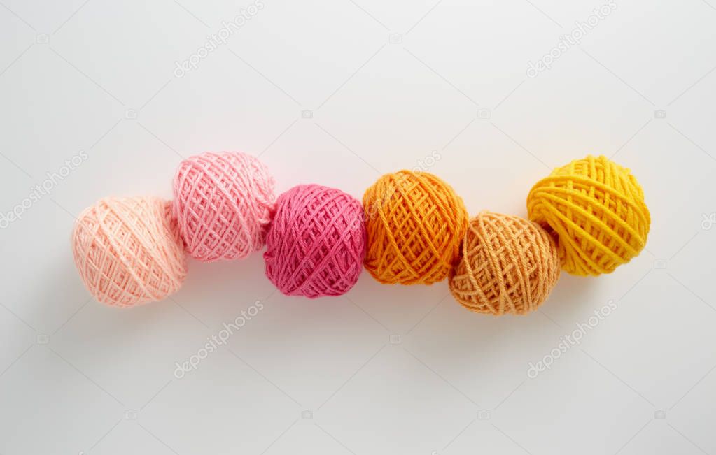 Knitting yarn balls in pink and yellow tone. 