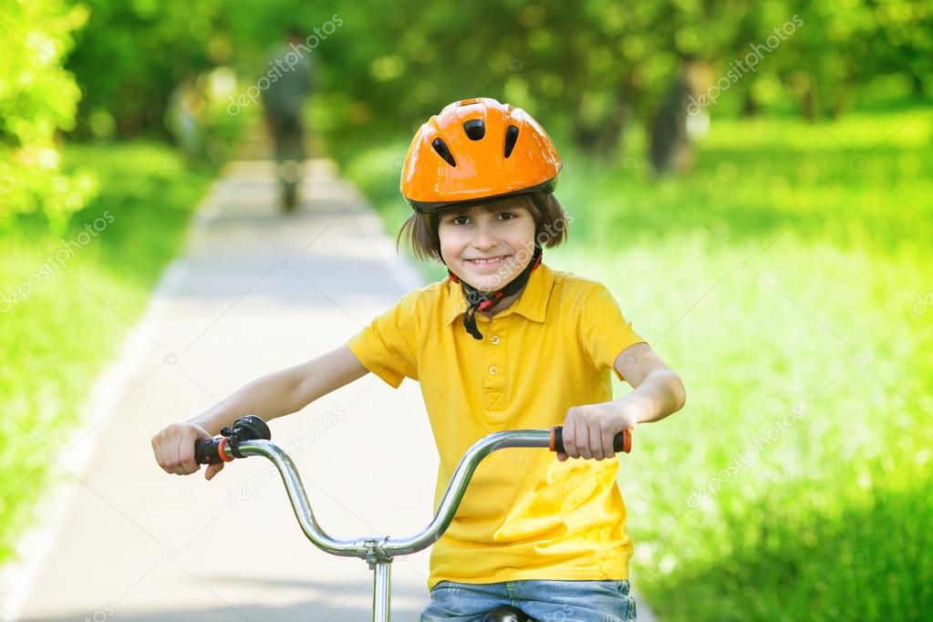 A kid at bike in city park
