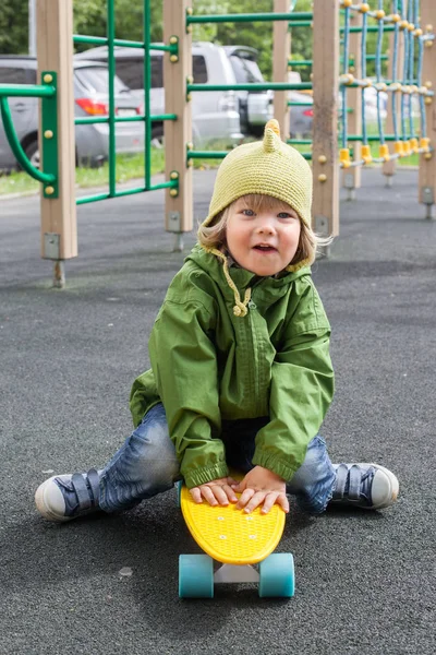 Kaykay üzerinde oturan erkek bebek — Stok fotoğraf