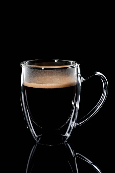 Black coffee in a glass transparent cup on a black background — Stock Photo, Image