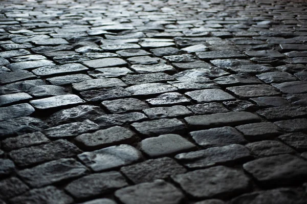 Background texture old road from large old stones leaves in perspective — Stock Photo, Image