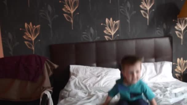 Saltando criança de 5 anos no quarto dos pais — Vídeo de Stock