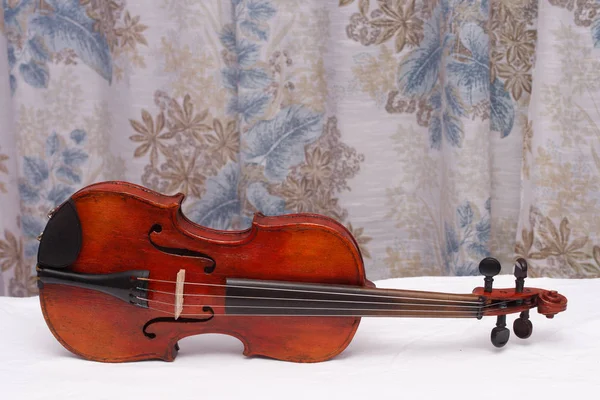 Broken antique red violin for restoration with damage