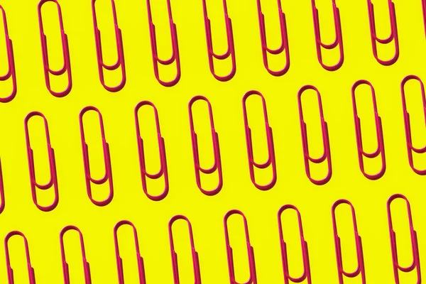 Pink paper clips on yellow background — ストック写真