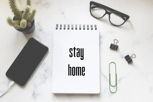 Flat lay of work space essentials with text stay home — Stock Photo, Image