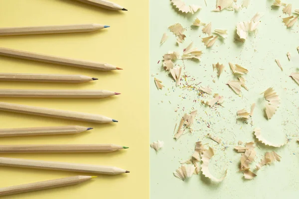 Lápis de cor raspas e lápis em um fundo verde amarelo e hortelã — Fotografia de Stock
