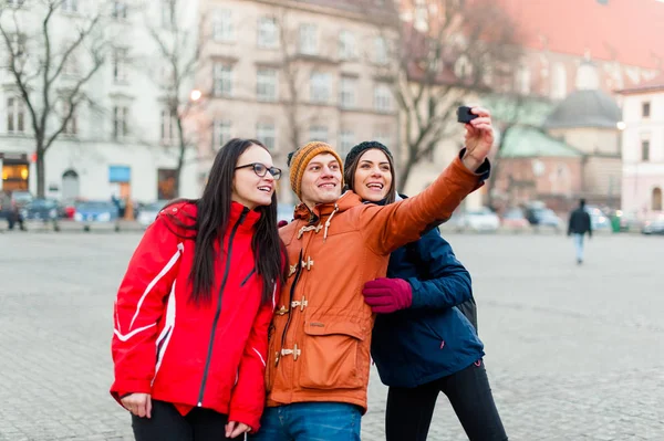 Friends tacking selfies with wearable camera in a touristic city