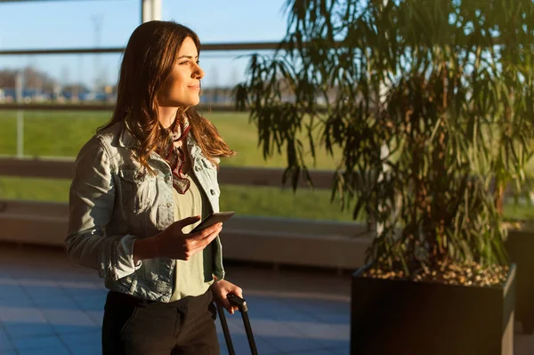 Vrouw texting en met behulp van telefoon voordat je in het vliegtuig — Stockfoto