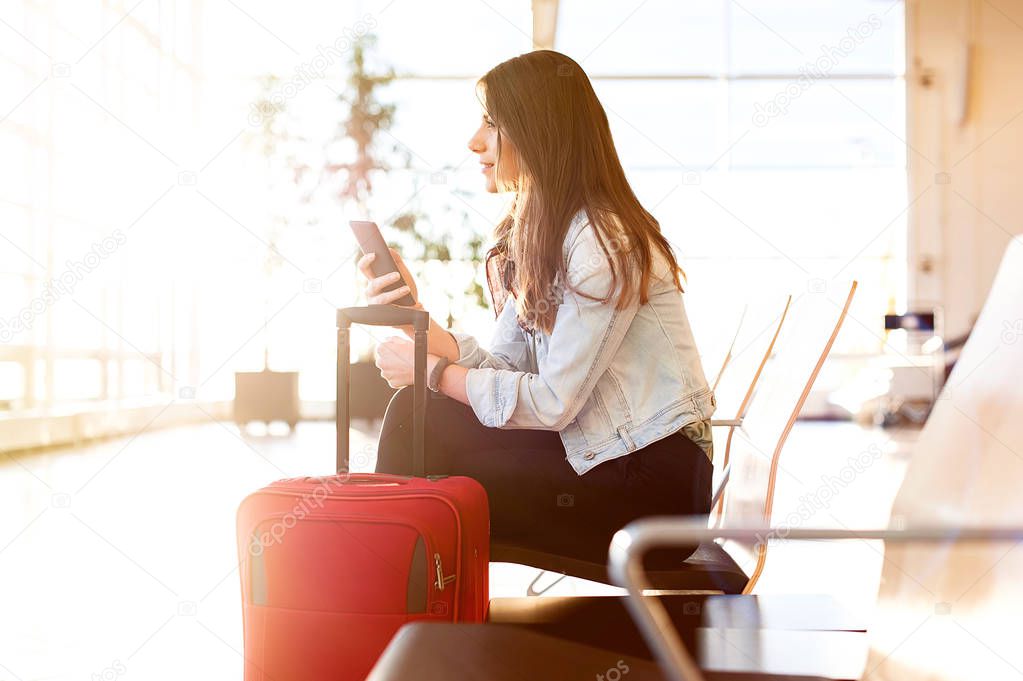 Woman texting and using phone before getting on the plane