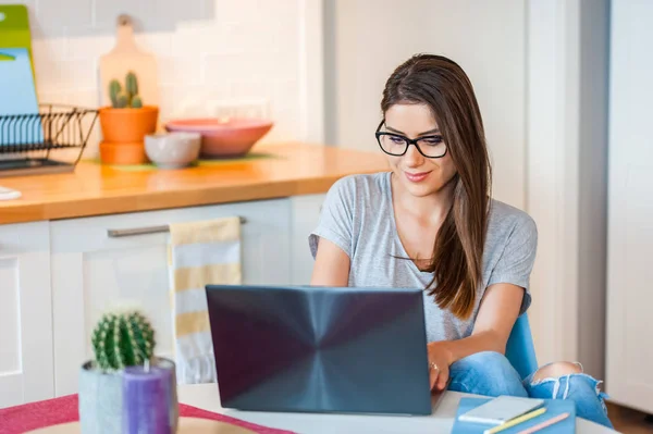 Chica usando el ordenador portátil sentado cómodo en casa —  Fotos de Stock